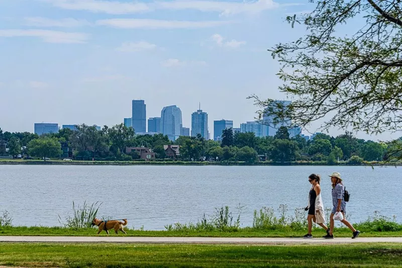 Image: People walk near Sloan's Lake.