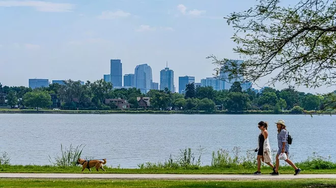 People walk near Sloan's Lake.