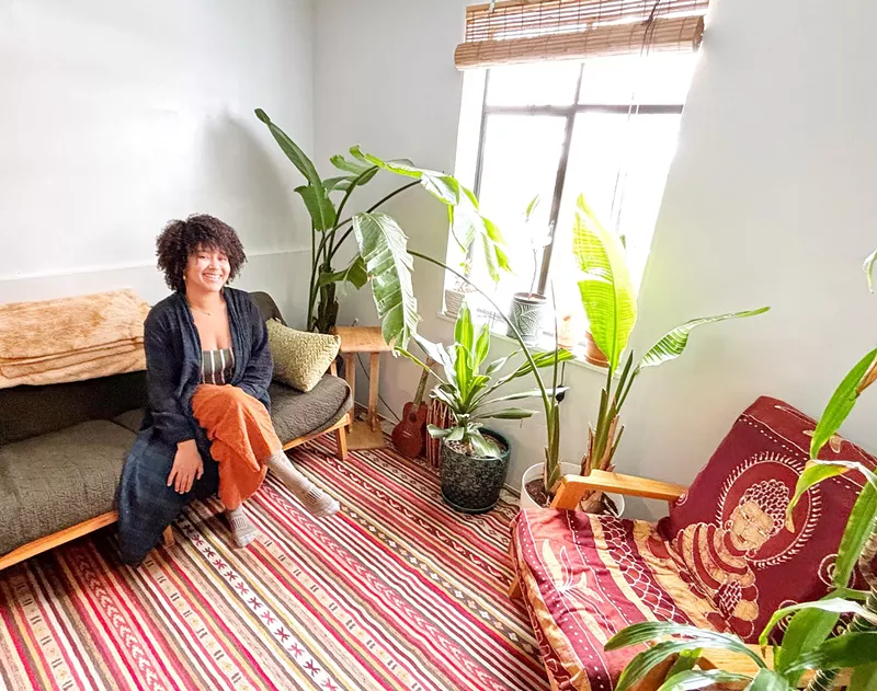 Image: woman sitting in a room with plants