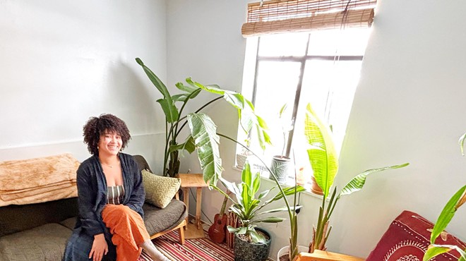 woman sitting in a room with plants
