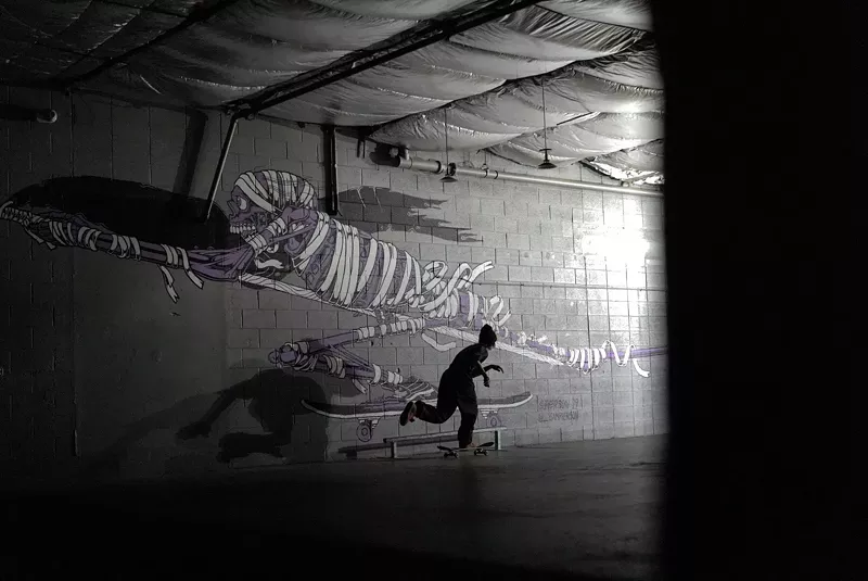 Image: Kiernan McGinnis riding a skateboard inside Curbside.