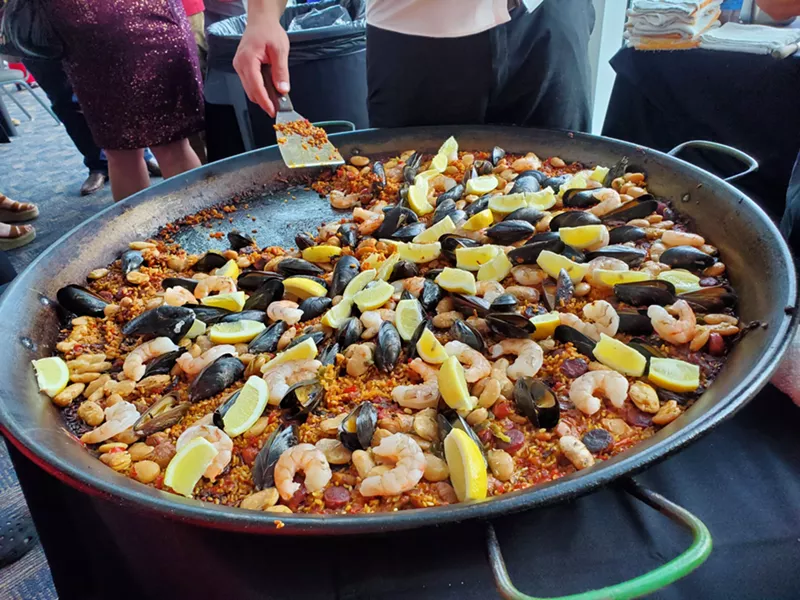 Image: a large pan filled with rise, mussels and shrimp