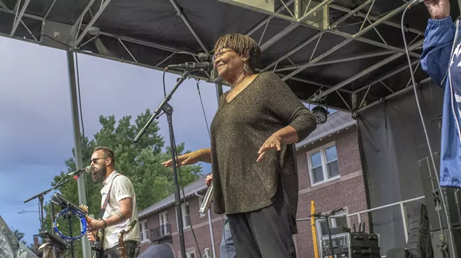 soul singer singing into microphone on stage