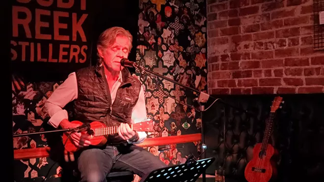 man playing ukulele