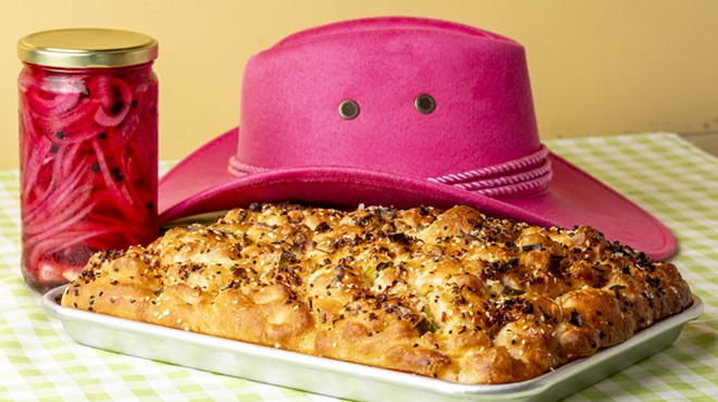 foccacia on a pan in front of a pink cowboy hat