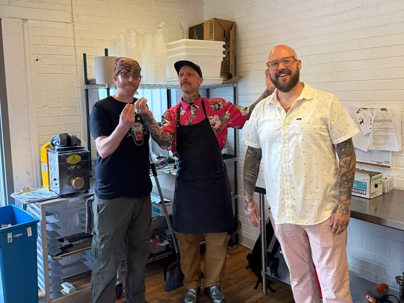 Image: three menu posing in a kitchen
