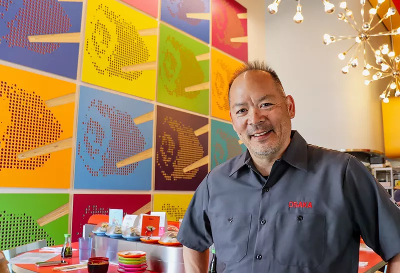Image: man in front of a brightly colored mural
