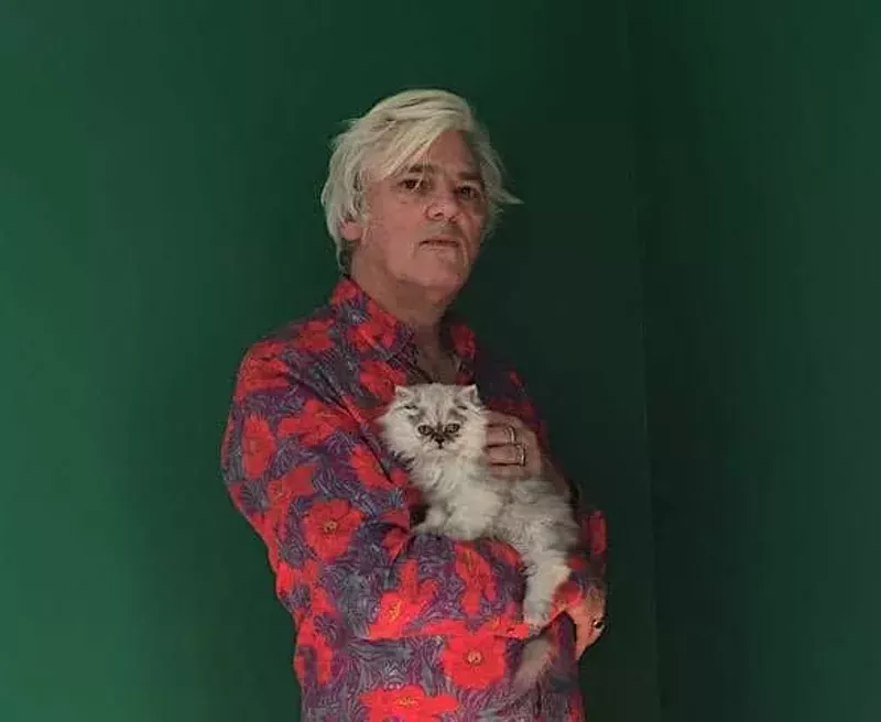 Image: man in red shirt with cat