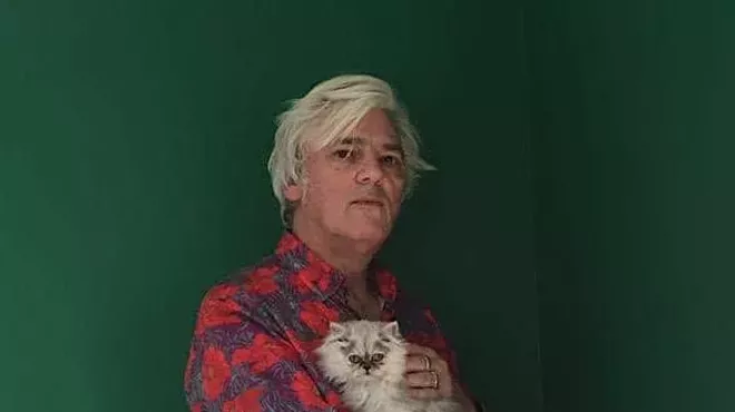 man in red shirt with cat