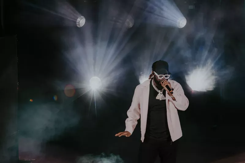 Image: A photo of T-Pain on stage performing at Red Rocks in Morrison, Colorado.