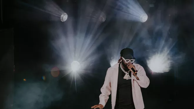 A photo of T-Pain on stage performing at Red Rocks in Morrison, Colorado.