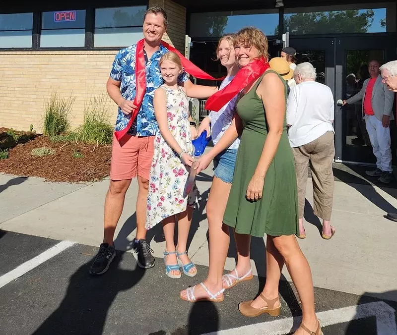 Image: family in front of community space