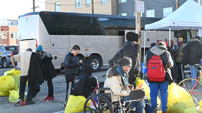 Homeless residents prepare to board a bus bound for housing.