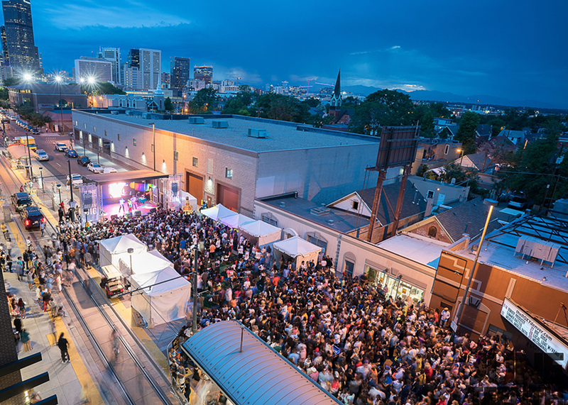 Image: a parade festival takes over a street in Denver