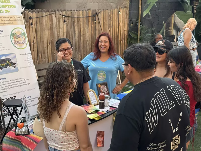 Image: People gather around table in backyard