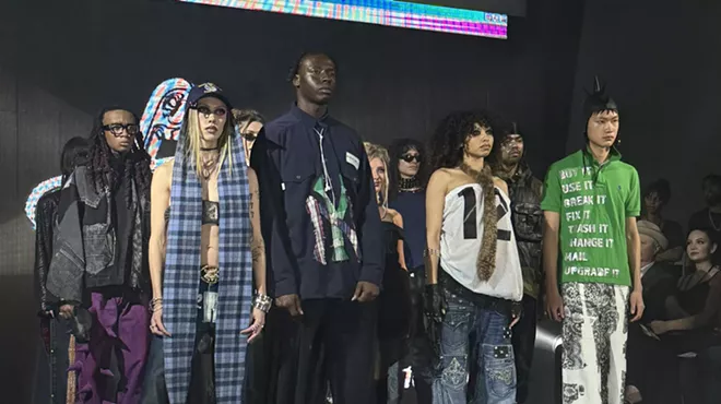Models stand next to each other in a dark room