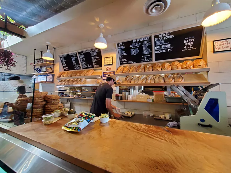Image: a man behind a deli counter
