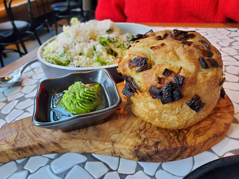 Image: round loaf of Focaccia and a Caesar salad