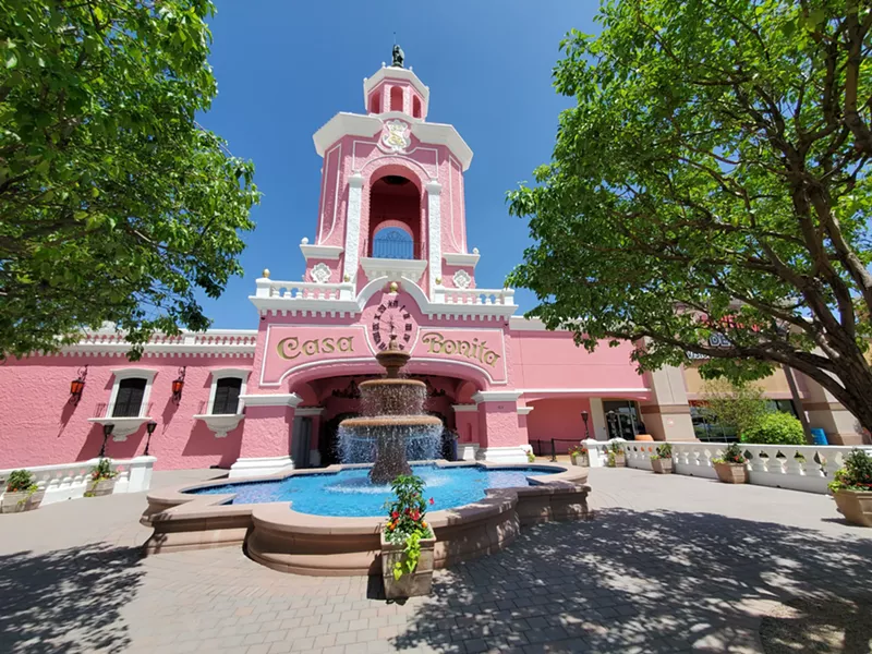 Image: a pink building with a flowing fountain out front