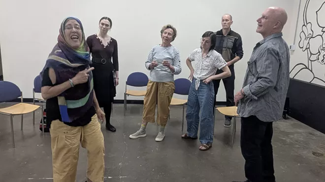A group of people stands in a room.