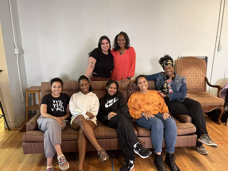 Image: actors sitting on a couch