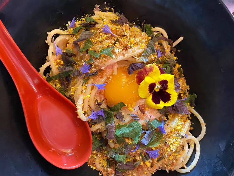 Image: a spaghetti dish with an egg yolk
