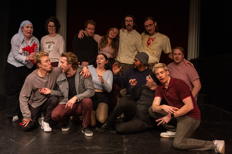 Image: People pose together in a theater.