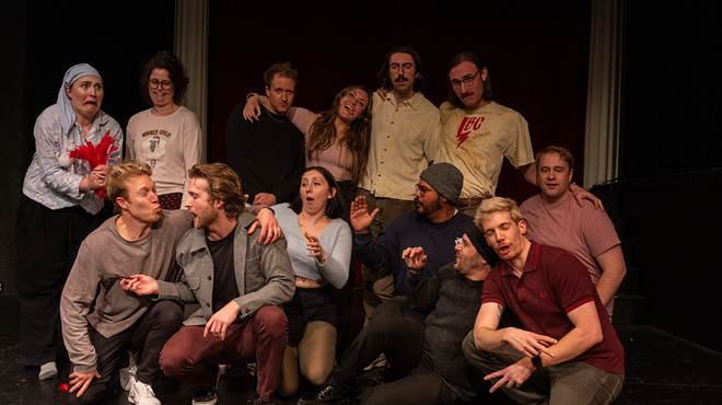 People pose together in a theater.