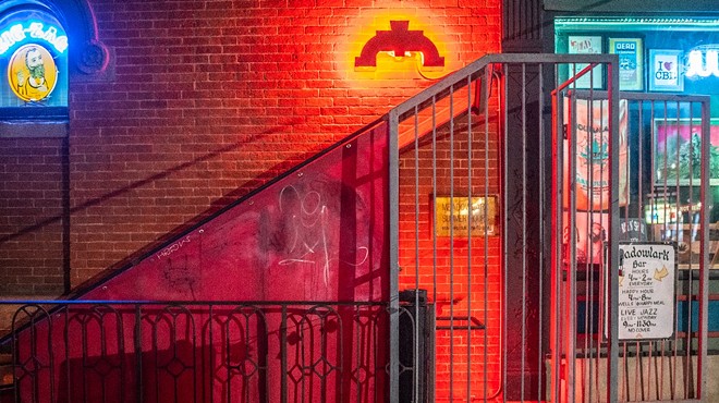 entrance to a basement bar with red light