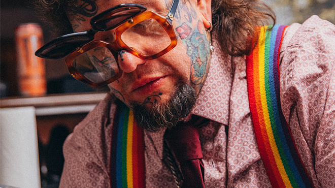 man with tattoos and rainbow suspenders wearing flipshade sunglasses
