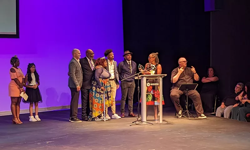 Image: people accepting an award on stage