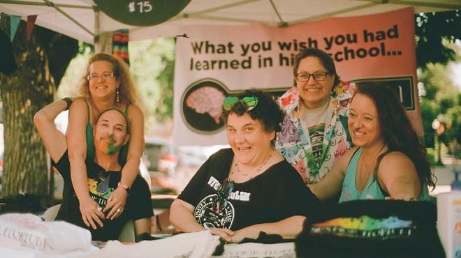 women laughing at a booth