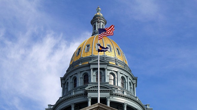 Colorado State Capital dome against blue sky with American flag