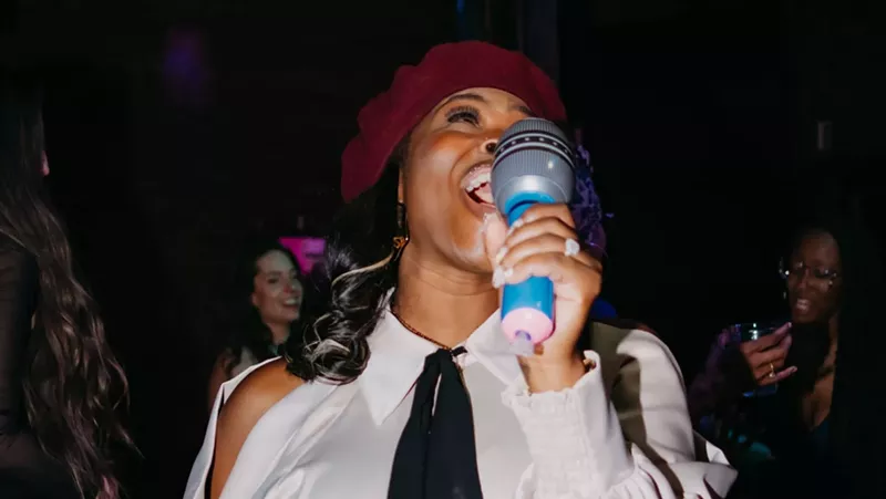 Image: woman holding inflatable mic