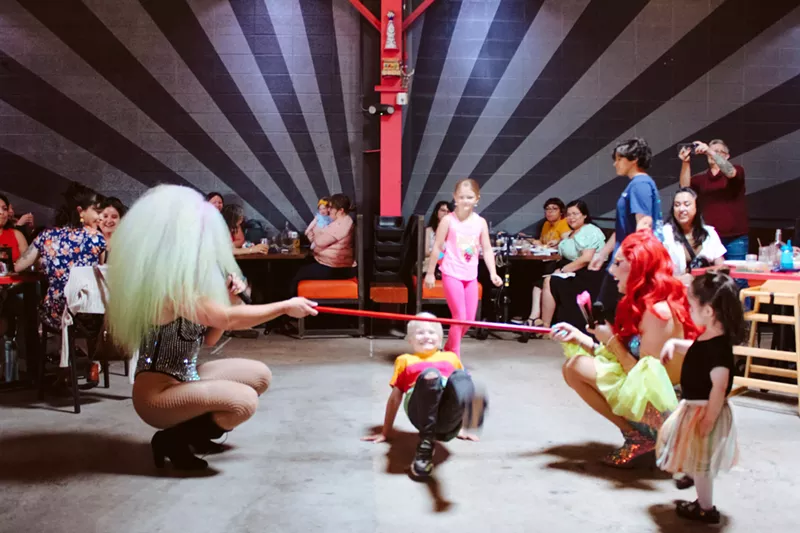 Image: drag queens do limbo with kids