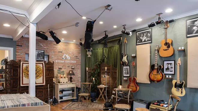 a room with guitars on the wall