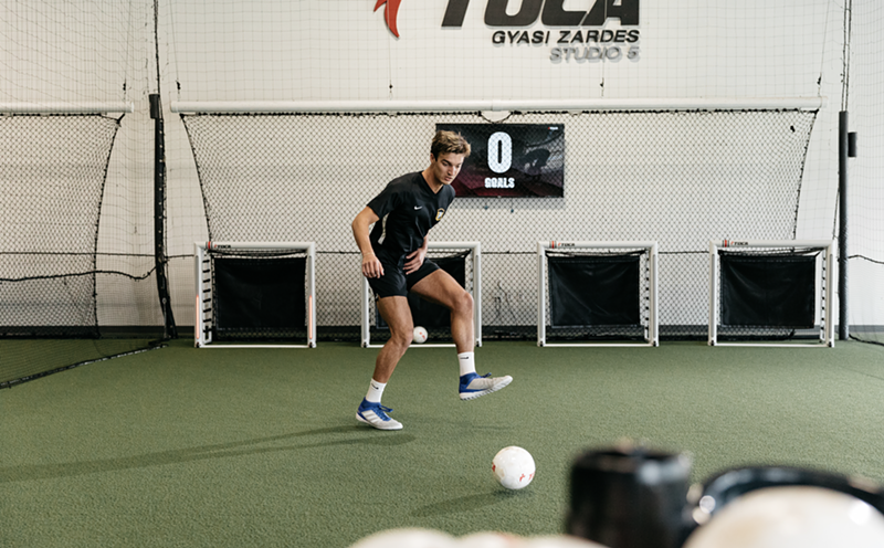 A machine deploys mini soccer balls during TOCA training sessions.
