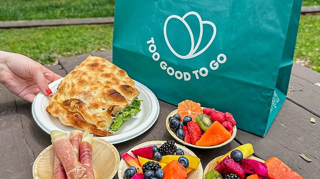 various food on plates in front of a green bag