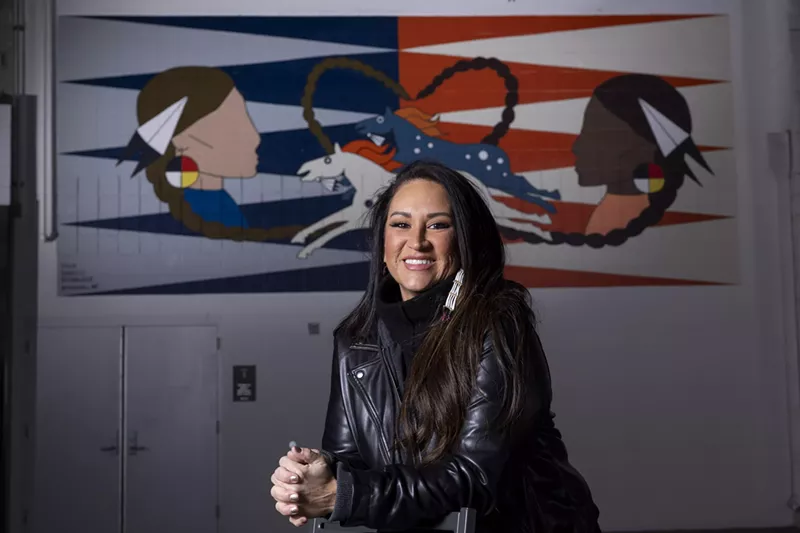 Image: woman sitting in front of art