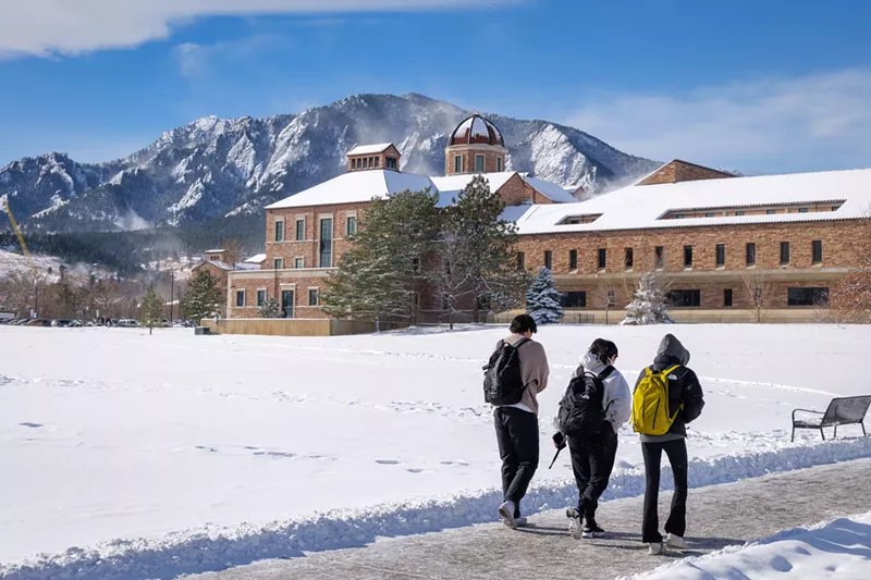Image: Three students walk across the University of Colorado Boulder campus on a snowy day on the first day of the 2025 spring semester.