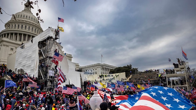 scene outside U.S. Capitol, flags, protesters
