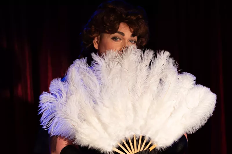Image: person with feather fan