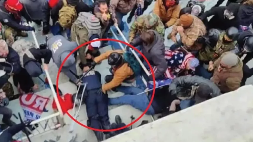Prosecutors contend that Jeffrey Sabol is the man wearing the tan jacket and green backpack in the circled area who helped drag a police officer down a flight of stairs. - JUSTICE.GOV