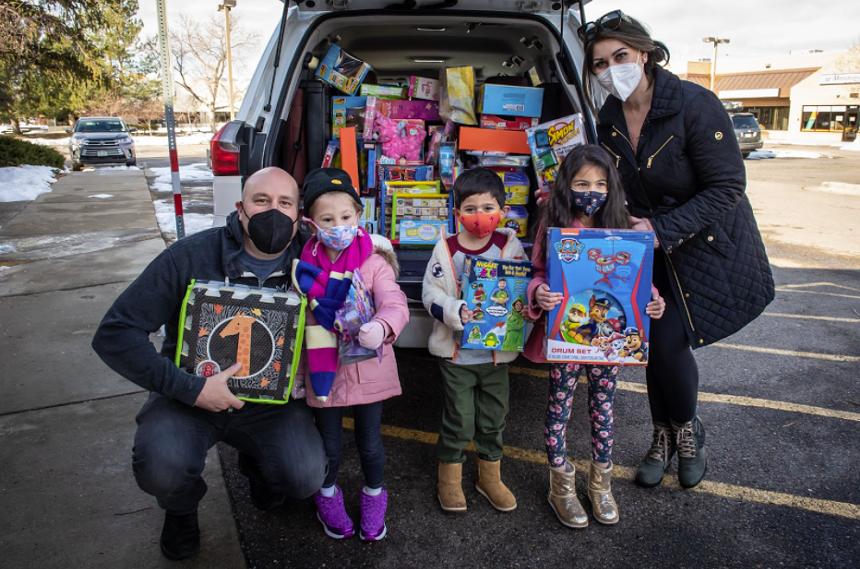 Hosea Rosenberg (left) accepting toy donations. Many kids have donated their Christmas presents to replace Christmas presents lost in the fire. - HOSEA ROSENBERG