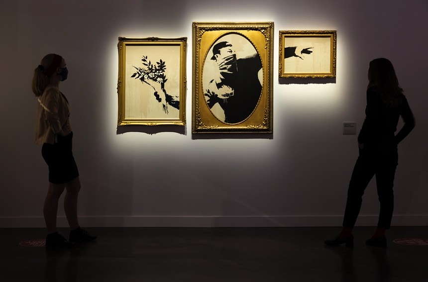 "Flower Thrower" is one of Banksy's well-known works at the exhibit. - KYLE FLUBACKER