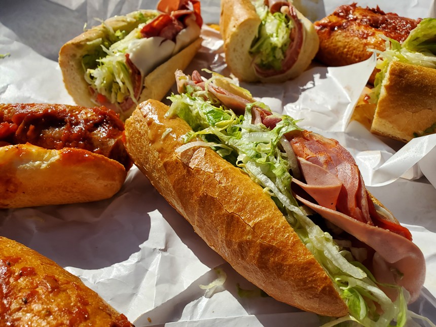 several large large sandwiches on baguettes