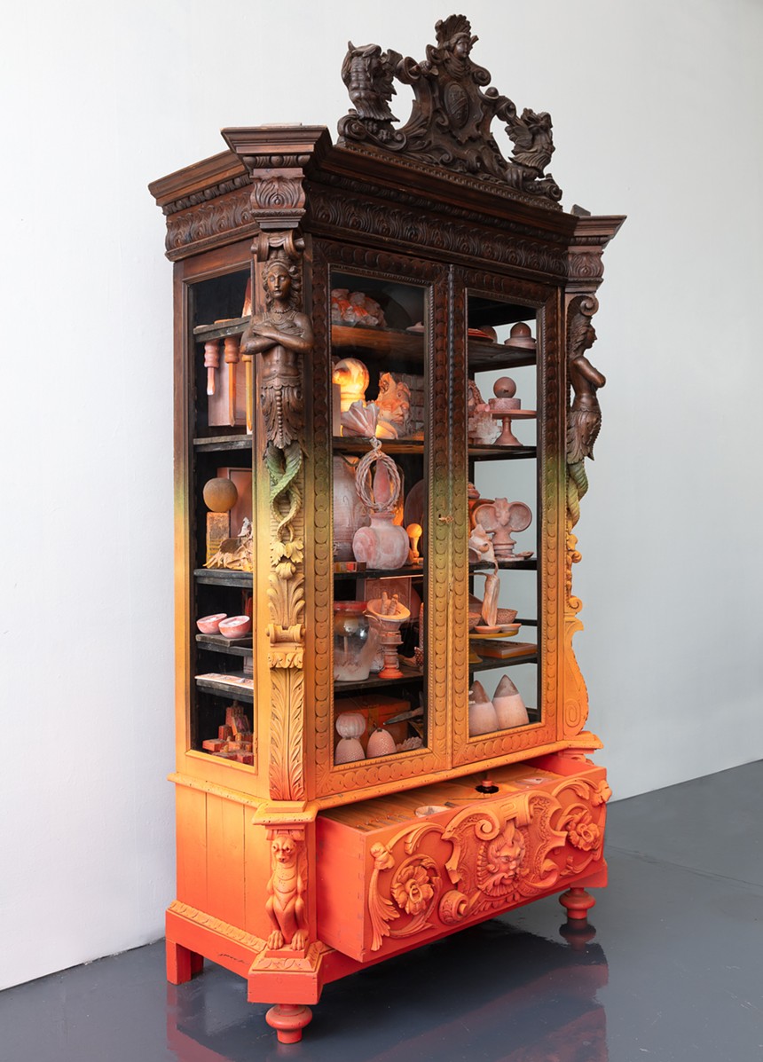 Jonathan Saiz, "Fire (Cabinet No. 1)," 2021, vintage carved wood cabinet (Spain ca 1850s) filled with handmade terra cotta idols, fertility fetishes, gemstones, human teeth and secret objects of personal meaning, and encasing six wish-granting candles. - JONATHAN SAIZ, K CONTEMPORARY