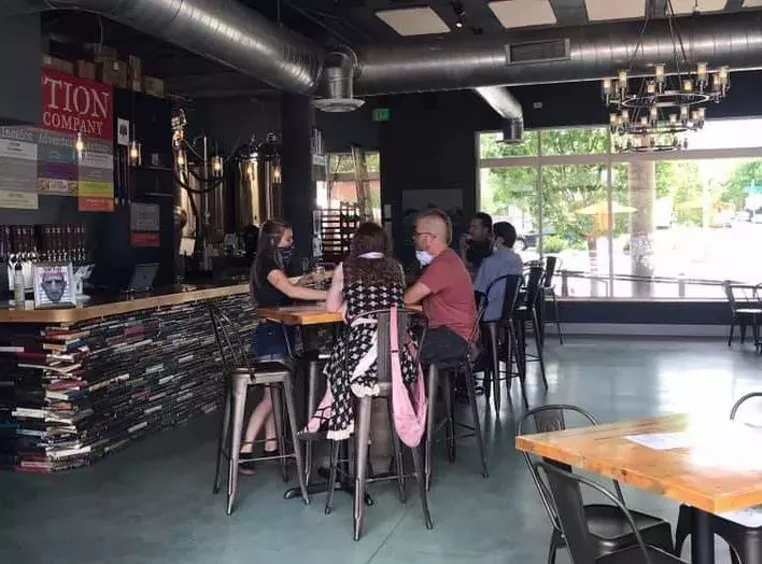 Fiction Beer Company's bar is made out of old books. - FICTION BEER