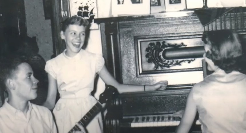 Maggie Peterson (center) with her brother on banjo and sister on piano.  - YOUTUBE