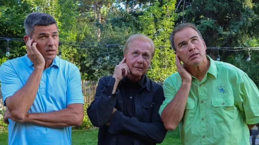 A 2017 photo of 9News anchor Tom Green, former 9News anchor Mark Koebrich and Jim Benemann engaging in a "'Newsman Pretending to Listen to Producer' competition." - COURTESY OF TOM GREEN
